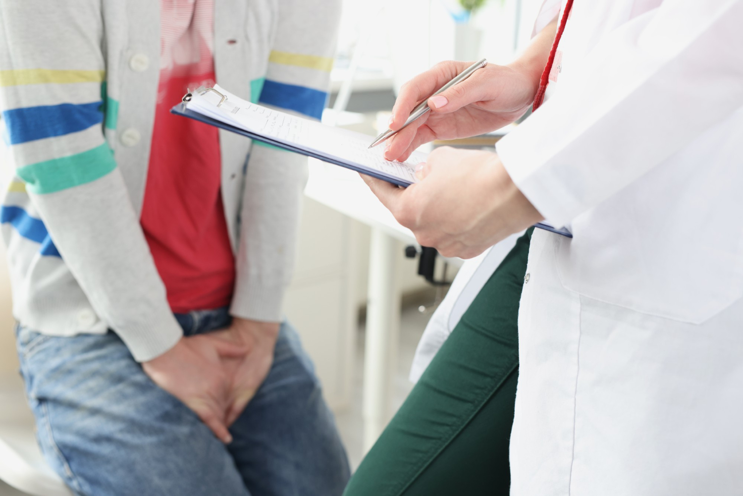 man-sitting-doctor-appointment-holding-genital-area-closeup